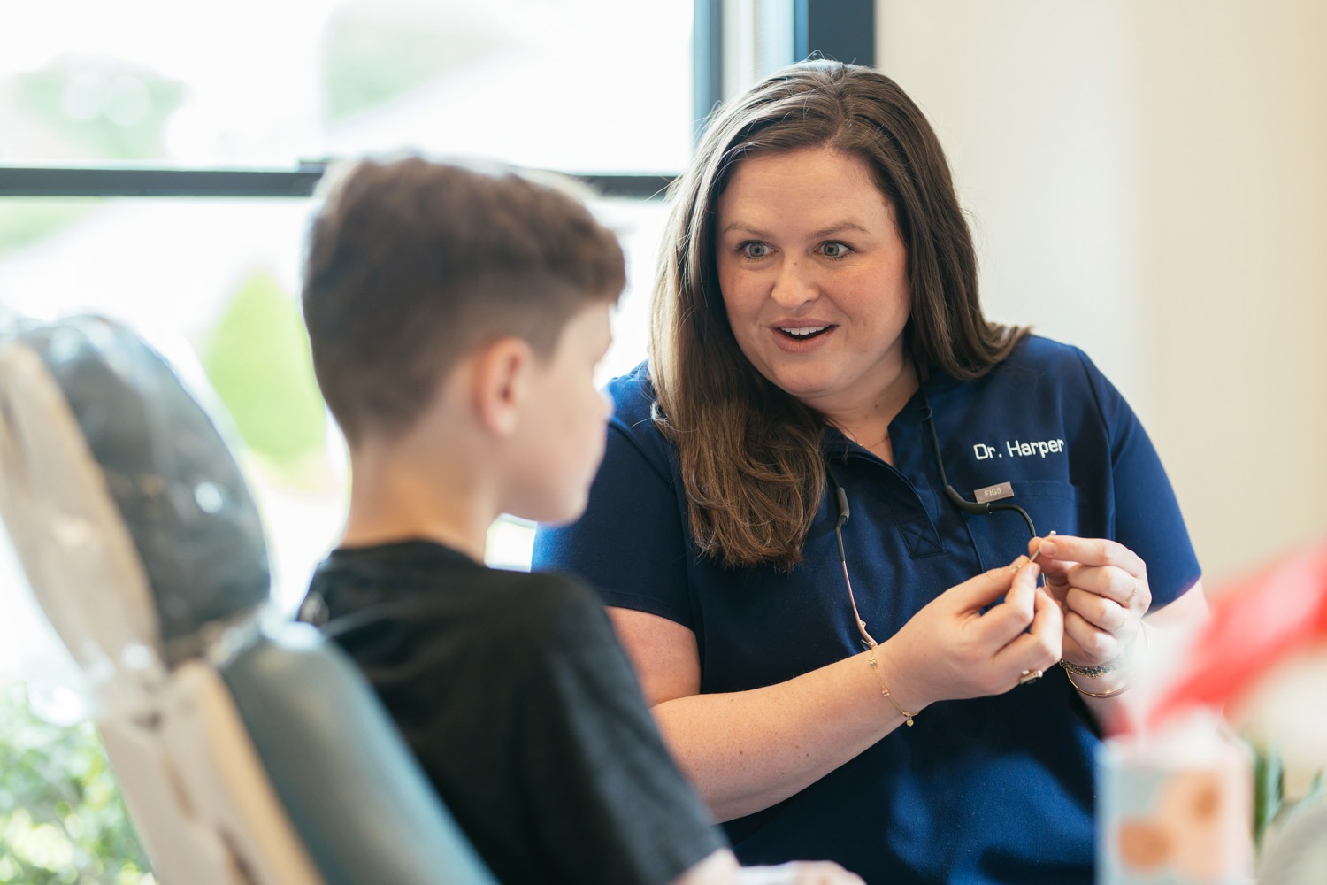 Pediatric orthodontist Dr. Harper explaining jaw growth treatment to a young patient at Sturgill Orthodontics in Johnson City