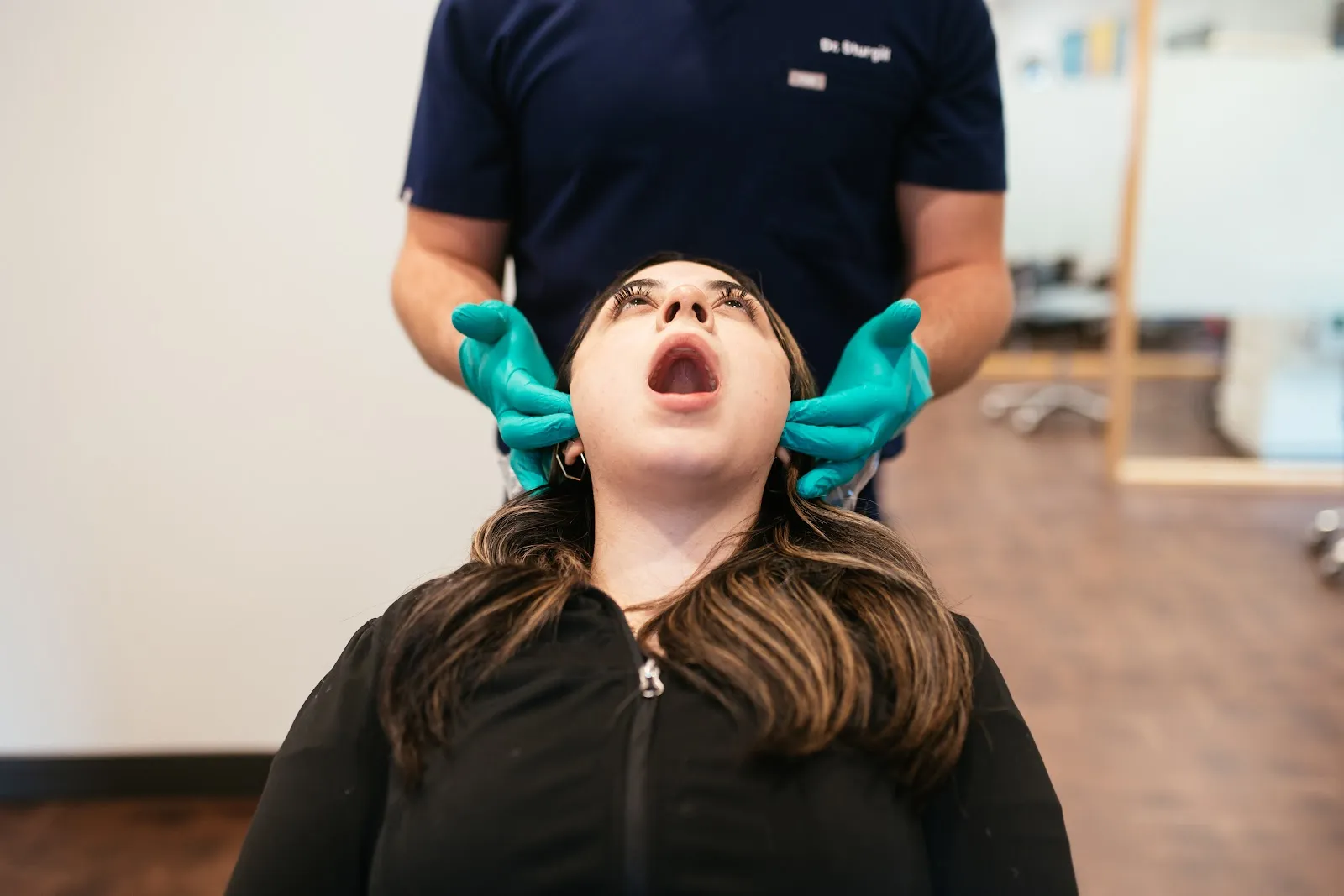 Orthodontist at Sturgill Orthodontics checking an adult patient's jaw and bite during an airway and TMJ exam for Bristol, VA and Bristol, TN adults