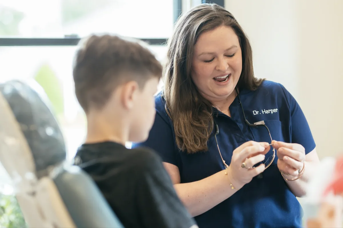 Dr. Anne Miller Harper of Sturgill Orthodontics talking with a young patient during an orthodontic visit